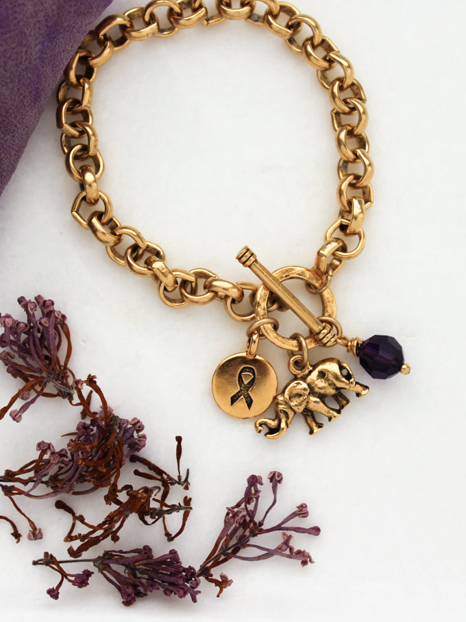Alzheimer's bracelet with gold elephant, awareness ribbon, and purple crystal