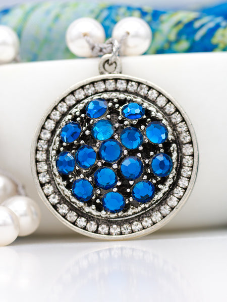 bright blue vintage center with rhinestones in silver setting with pearls