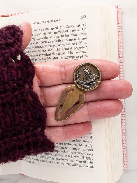 small bookmark with antique button in hand